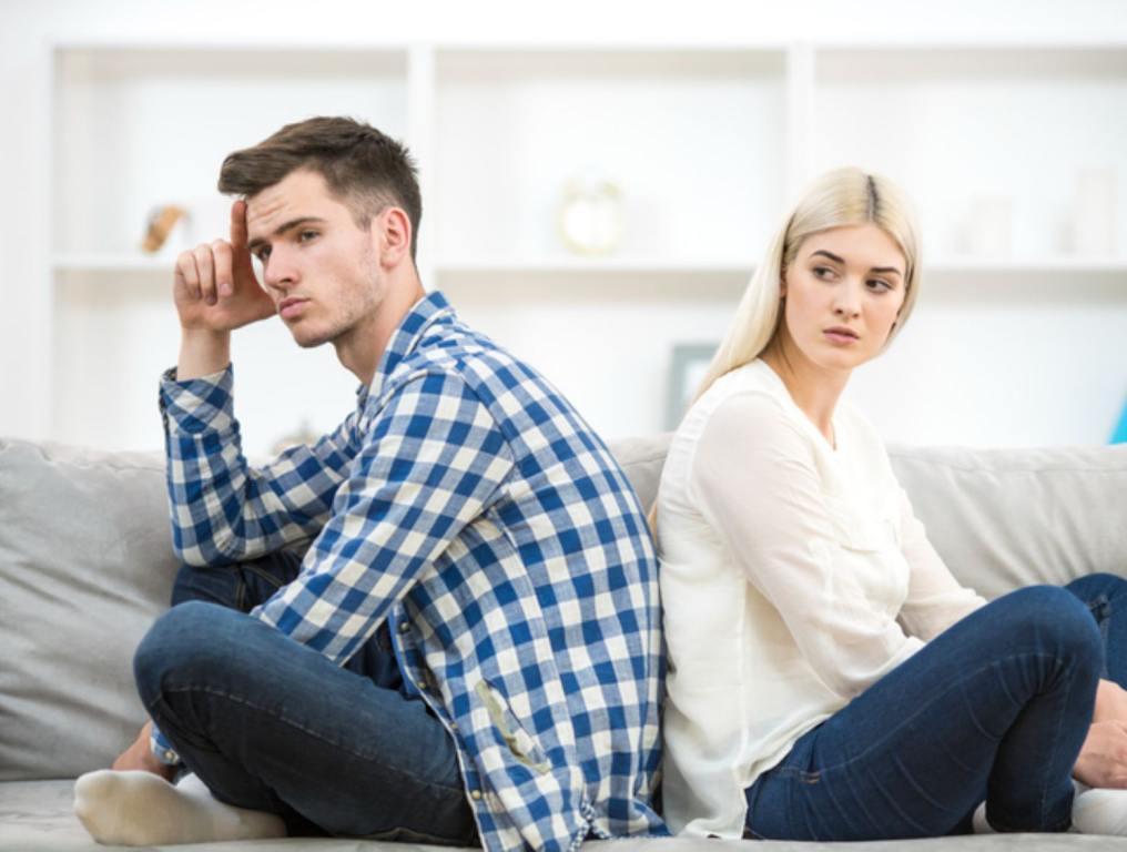 Couple fighting on the couch.