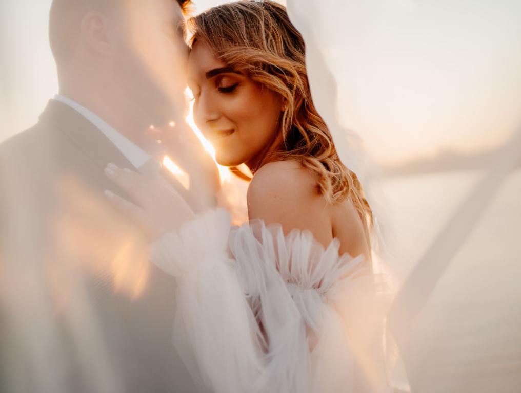 A couple dancing outside by the ocean.