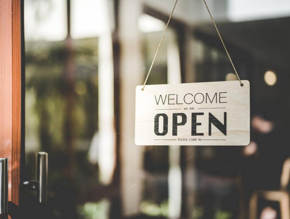 Open sign hanging front of cafe with colorful bokeh light abstract background. Business service and food concept. Vintage tone filter effect color style. What Is Open On Easter Sunday In Tampa Bay