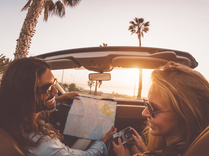 Happy young couple doing road trip in tropical city. A Florida Road Trip