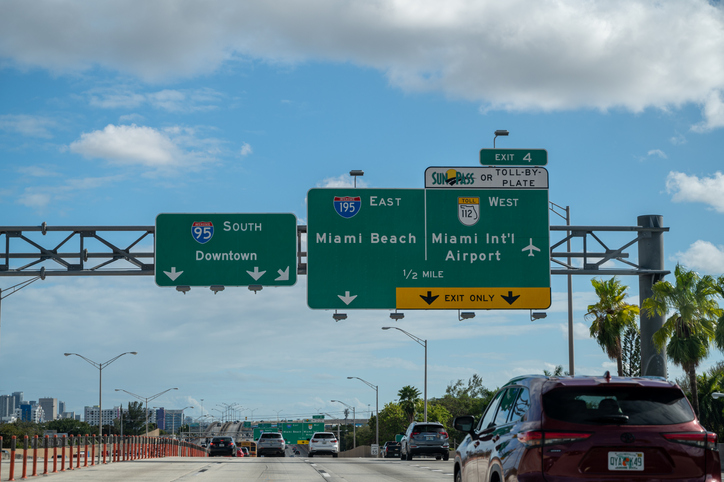 Is The Florida SunPass Worth It? - A windshield view of the miami road signs on the toll road with the SunPass lanes.